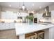 Bright kitchen features quartz countertops, stainless steel appliances, and a large island at 3118 E Gary Way, Phoenix, AZ 85042