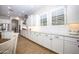 Spacious kitchen with white cabinets, granite countertops, stainless steel appliances, and wood-look tile flooring at 3118 E Gary Way, Phoenix, AZ 85042