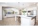 Bright kitchen with white cabinets, granite countertops, stainless steel appliances, and an island with seating at 3118 E Gary Way, Phoenix, AZ 85042