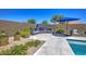 Outdoor fireplace and seating area with manicured landscaping and access to the refreshing pool at 3118 E Gary Way, Phoenix, AZ 85042
