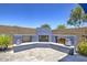 Backyard patio with a built-in fireplace surrounded by a low stone wall at 3118 E Gary Way, Phoenix, AZ 85042