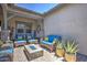 Covered patio with stone columns, cozy outdoor furniture, and a fire pit at 3118 E Gary Way, Phoenix, AZ 85042