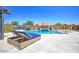 Loungers poolside offer a perfect space to enjoy the pool, jacuzzi and outdoor fireplace at 3118 E Gary Way, Phoenix, AZ 85042