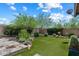 Beautifully landscaped backyard with green artificial turf and desert vegetation at 31409 N 58Th Pl, Cave Creek, AZ 85331