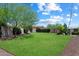 Expansive backyard with lush green grass and mature trees, offering privacy and space at 31409 N 58Th Pl, Cave Creek, AZ 85331