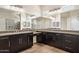 Modern bathroom features dual sinks, dark cabinets, granite countertop and tiled shower with glass door at 31409 N 58Th Pl, Cave Creek, AZ 85331