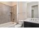 Bathroom with tub and tiled wall surround, chrome fixtures, dark vanity and white countertop at 31409 N 58Th Pl, Cave Creek, AZ 85331