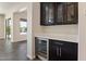 Elegant dining area with dark cabinets, quartz countertop, and a built-in wine cooler at 31409 N 58Th Pl, Cave Creek, AZ 85331