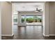 Bright living room featuring wood-look tile floors and sliding glass doors to the outdoor pool area at 31409 N 58Th Pl, Cave Creek, AZ 85331