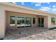 Covered patio with travertine flooring and large windows, seamlessly connecting indoor and outdoor living at 31409 N 58Th Pl, Cave Creek, AZ 85331