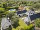 Expansive aerial view of the backyard featuring a sparkling pool, lush landscaping, and a charming patio area at 325 W Solano Dr, Phoenix, AZ 85013