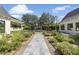 Beautiful backyard with a stone path leading to an outdoor fireplace, surrounded by greenery at 325 W Solano Dr, Phoenix, AZ 85013