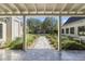 Backyard view framed by pillars, showcasing a stone pathway, trees, and outdoor fireplace at 325 W Solano Dr, Phoenix, AZ 85013