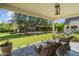 Covered patio with comfortable seating overlooking a spacious backyard with an outdoor fireplace at 325 W Solano Dr, Phoenix, AZ 85013