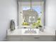 Bright bathroom featuring a modern sink, elegant mirror, and natural light from the window at 325 W Solano Dr, Phoenix, AZ 85013