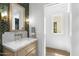 Stylish bathroom featuring a marble vanity, elegant mirror, and herringbone tile accent wall at 325 W Solano Dr, Phoenix, AZ 85013