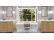 Spa-like bathroom with a soaking tub nestled between two vanities and bright natural light at 325 W Solano Dr, Phoenix, AZ 85013