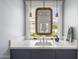 Stylish bathroom with a contemporary sink, wood-trimmed mirror, and under-cabinet storage at 325 W Solano Dr, Phoenix, AZ 85013