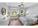Light filled bedroom with hardwood floors and a cozy window seat at 325 W Solano Dr, Phoenix, AZ 85013