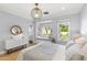 Sunlit bedroom features a reading nook and stylish light fixture at 325 W Solano Dr, Phoenix, AZ 85013