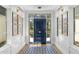 Stylish entryway featuring wainscoting, unique wall art, and a decorative blue tile rug to accent the design at 325 W Solano Dr, Phoenix, AZ 85013
