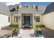 An inviting front door with elegant hardware and sidelights, complemented by lush landscaping and charming flower planters at 325 W Solano Dr, Phoenix, AZ 85013