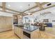 Gourmet kitchen with a large island, modern appliances, and an open view into the living and dining areas at 325 W Solano Dr, Phoenix, AZ 85013