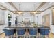 Spacious kitchen features a large center island with seating, modern appliances, and designer lighting at 325 W Solano Dr, Phoenix, AZ 85013