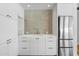 Charming kitchenette featuring sleek white cabinetry, stainless steel appliances, and a stylish backsplash at 325 W Solano Dr, Phoenix, AZ 85013