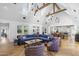 Spacious living room with vaulted ceilings, modern lighting, and views of the beautifully landscaped backyard at 325 W Solano Dr, Phoenix, AZ 85013