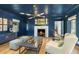 Navy living room featuring a marble fireplace, modern lighting, and stylish seating at 325 W Solano Dr, Phoenix, AZ 85013