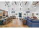 Open-concept living and dining area featuring high ceilings, wood beams, chandelier lighting, and views of the entryway at 325 W Solano Dr, Phoenix, AZ 85013