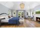 Bright main bedroom with high ceilings, fireplace, French doors, and hardwood floors at 325 W Solano Dr, Phoenix, AZ 85013