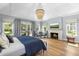 Bright main bedroom with high ceilings, fireplace, French doors, and hardwood floors at 325 W Solano Dr, Phoenix, AZ 85013