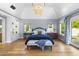 Spacious main bedroom with large windows, chandelier, and bench seating at 325 W Solano Dr, Phoenix, AZ 85013