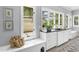 Bright mudroom with white cabinets, bench seating, and ample natural light from large windows at 325 W Solano Dr, Phoenix, AZ 85013