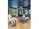 Inviting blue office with custom shelves, statement lighting, and large windows offering ample natural light at 325 W Solano Dr, Phoenix, AZ 85013