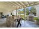 Outdoor patio with dining table and grill, with a view of the landscaped backyard at 325 W Solano Dr, Phoenix, AZ 85013