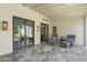 Cozy covered patio with comfortable seating, dark framed windows, and tiled floors at 325 W Solano Dr, Phoenix, AZ 85013
