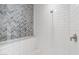 Bathroom shower features modern white subway and herringbone tile at 325 W Solano Dr, Phoenix, AZ 85013