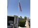 Carport featuring a parking spot with an American flag, desert landscaping, and ample parking at 3330 E Main St # 430, Mesa, AZ 85213