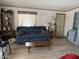 Inviting living room with natural light, comfortable sofa and laminate floors at 3330 E Main St # 430, Mesa, AZ 85213