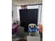 Enclosed porch area with black shelving, white seating, and storage containers at 3330 E Main St # 430, Mesa, AZ 85213