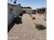 Wide view of side yard showing desert landscaping with gravel, small plants, and an AC unit at 3330 E Main St # 430, Mesa, AZ 85213