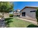 Exterior view of a home's backyard featuring a covered patio and block fencing at 363 W Bruce Ave, Gilbert, AZ 85233