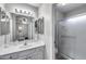 Bathroom with white cabinets, countertop, decorative mirrors, and a glass shower at 363 W Bruce Ave, Gilbert, AZ 85233