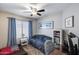 This bedroom is bright with a ceiling fan and window for natural light at 363 W Bruce Ave, Gilbert, AZ 85233
