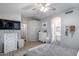 Bright bedroom featuring a ceiling fan, gray walls, and a mounted flatscreen TV at 363 W Bruce Ave, Gilbert, AZ 85233