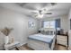This bedroom features a ceiling fan, carpeted floors and bright, neutral-colored walls at 363 W Bruce Ave, Gilbert, AZ 85233