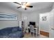 This carpeted bedroom has a ceiling fan and bright natural lighting at 363 W Bruce Ave, Gilbert, AZ 85233